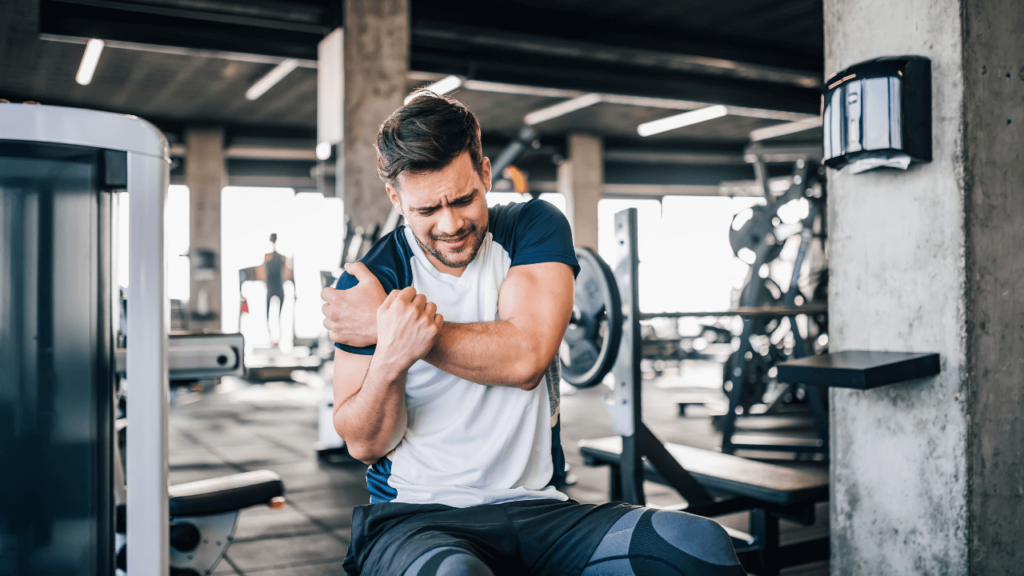 a man sitting on a bench in a gym.