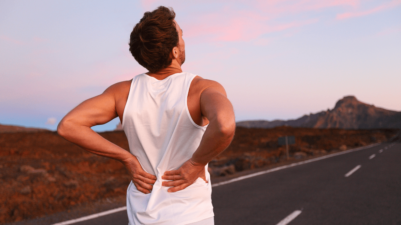 a man standing on the side of a road with his back to the camera