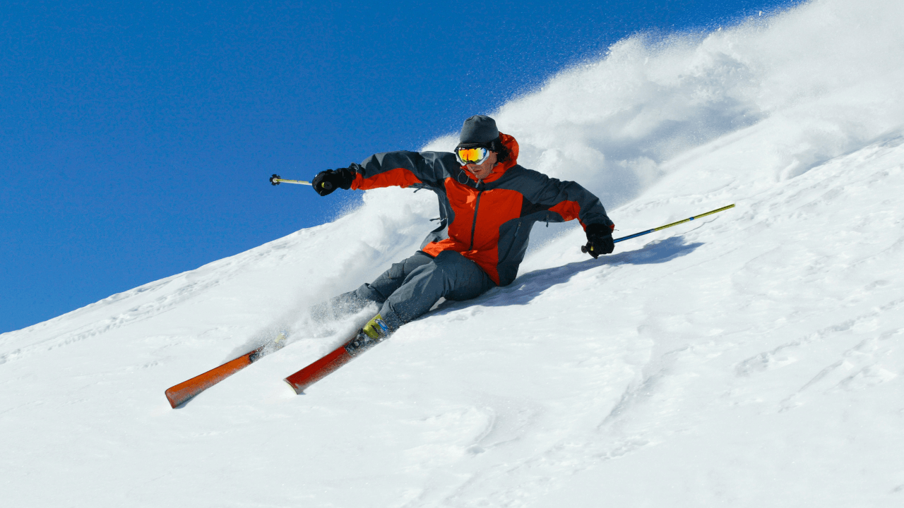 a man riding skis down a snow covered slope