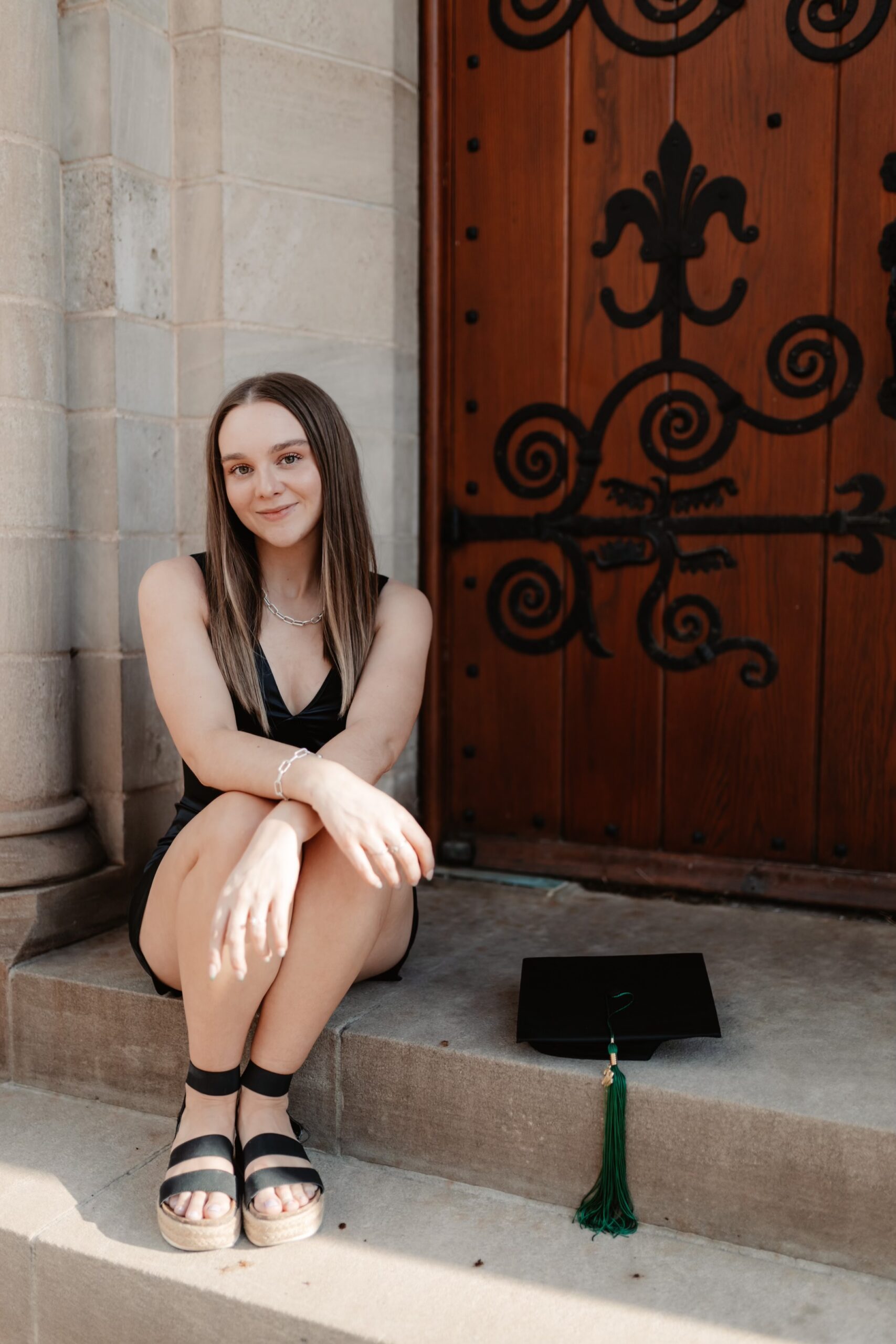 a woman sitting on the steps of a building.