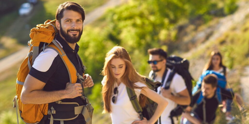 a group of people hiking with backpacks.